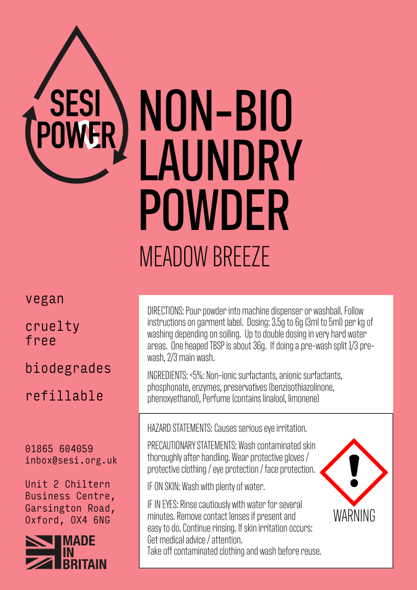 A pink product information card for SESI Non-Bio Laundry Powder in the Meadow Breeze scent. The card features black text detailing the product's features (vegan, cruelty free, biodegradable, refillable), directions, ingredients, and safety statements, along with a 'Made in Britain' logo.