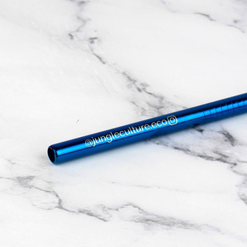 Blue straw with 'junglecultureeco' branding on a marble surface