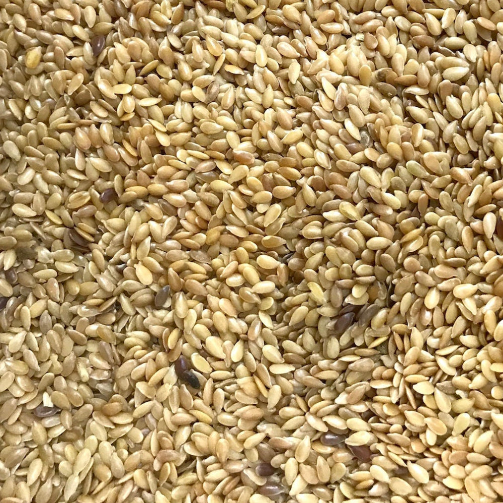 A close up of golden seeds of  Linseeds/Flaxseeds