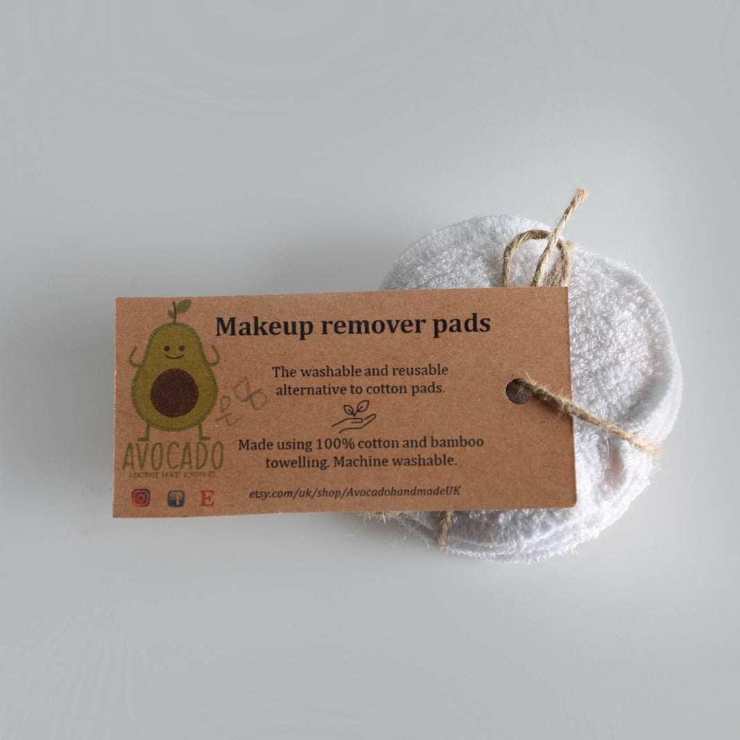 Makeup remover pads with a cardboard label on a light gray background