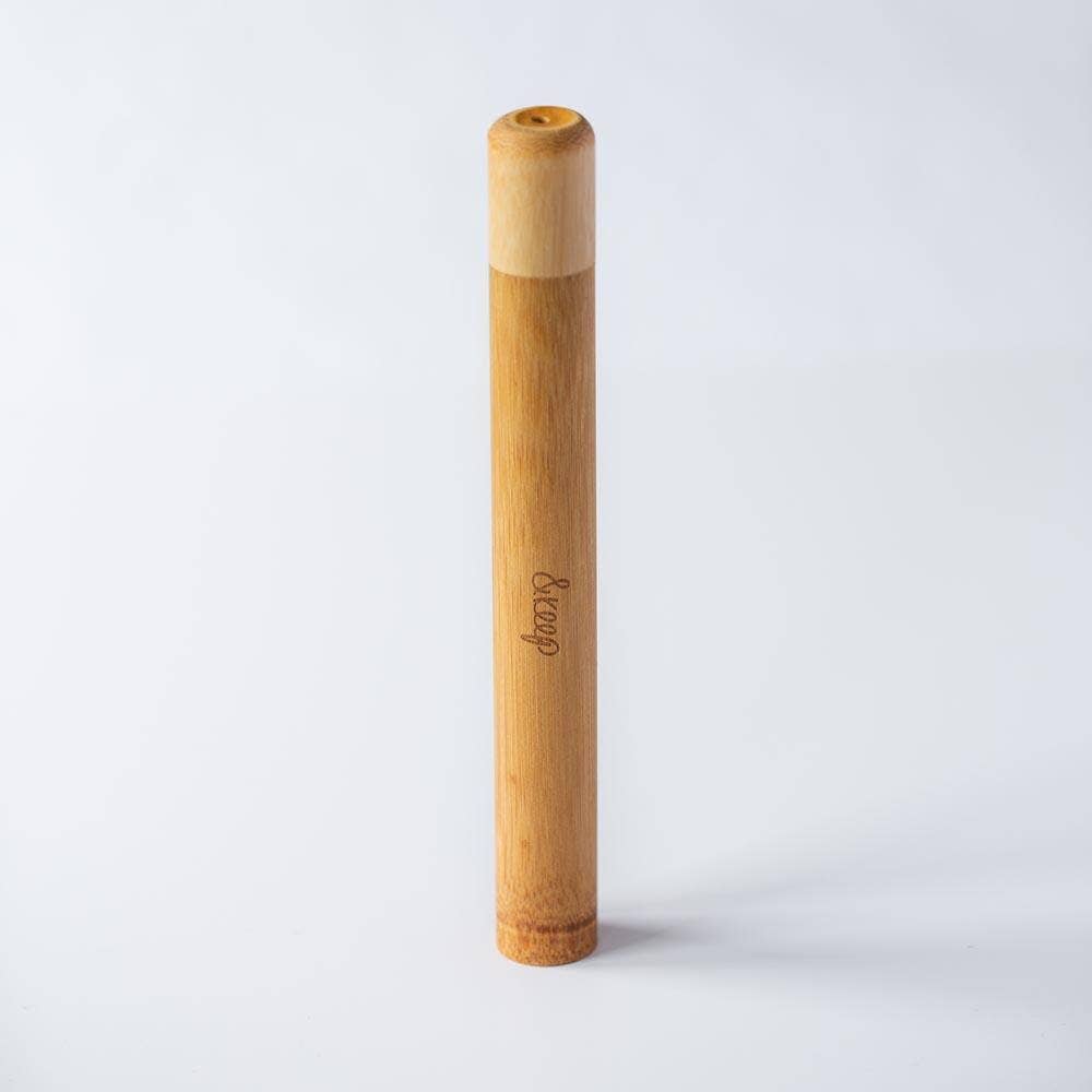 Bamboo travel toothbrush holder shown  on a white background