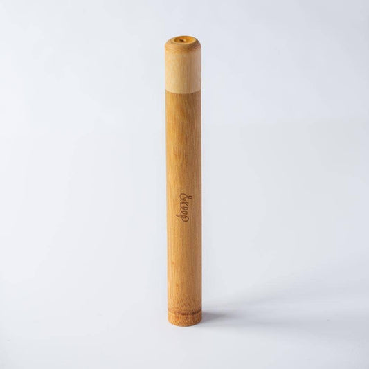 Bamboo travel toothbrush holder shown  on a white background