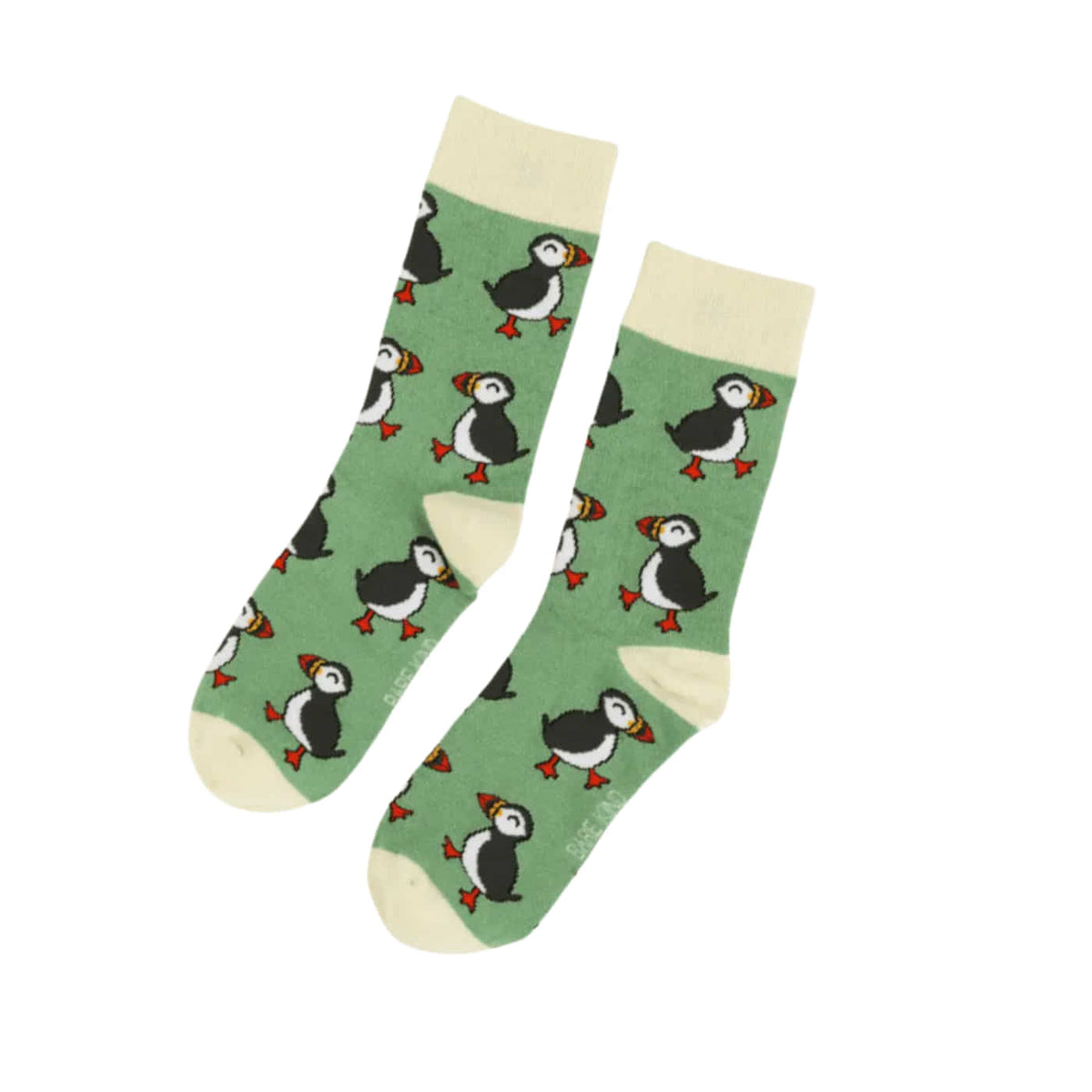 A pair of crew socks with a green background and a repeating puffin pattern, featuring cream-colored cuffs, heels, and toes on a white background.