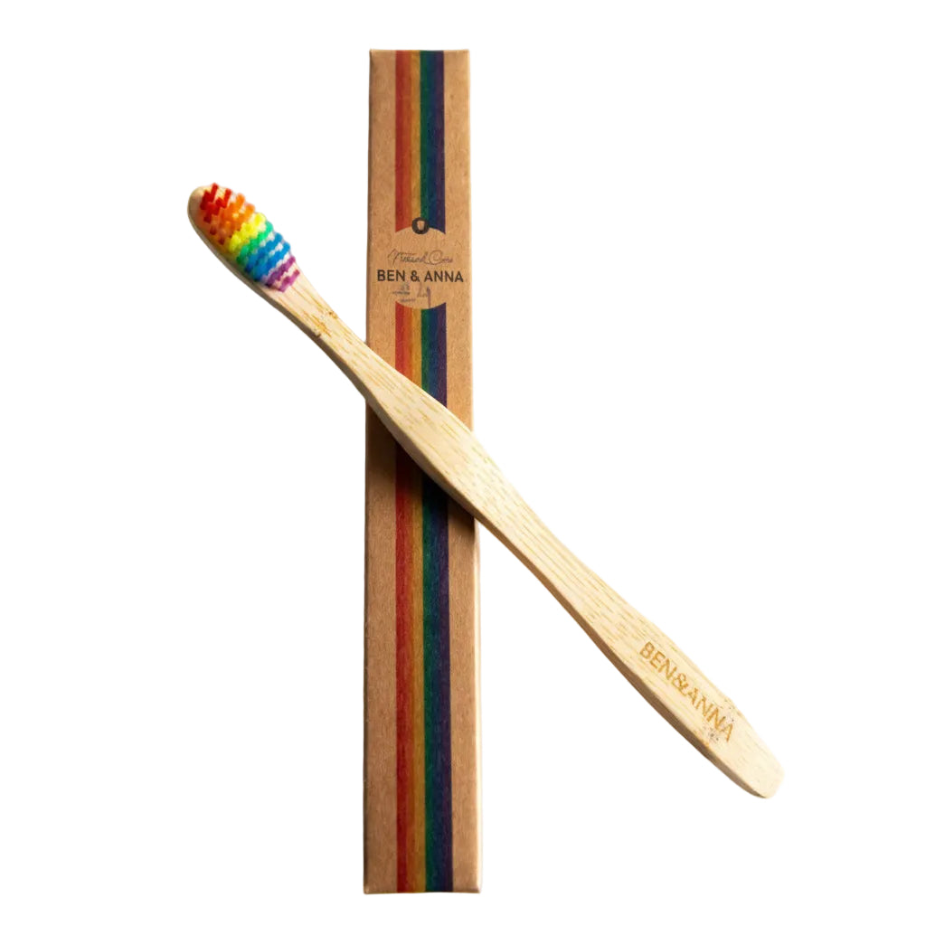 Bamboo toothbrush with rainbow bristles and packaging on a white background