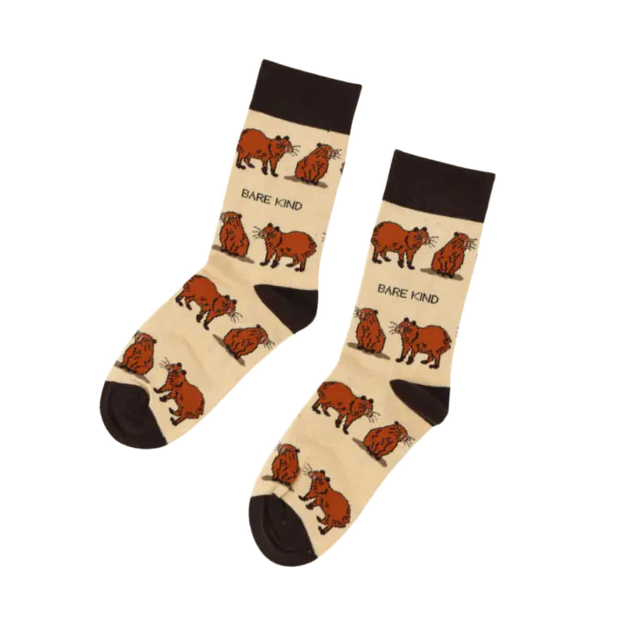 A pair of crew socks with a beige base, featuring a repeating pattern of cartoon capybaras in brown and black, with the text 'BARE KIND' printed between the illustrations. The socks have solid black cuffs, heels, and toes, and are displayed on a clean white background.