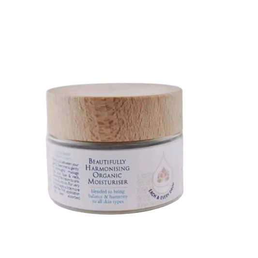 Jar of 'Beautifully Harmonising Organic Moisturiser' with a wooden lid on a white background