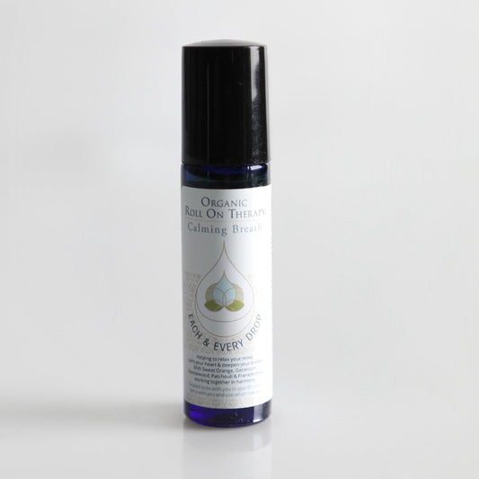 Roll-on bottle with black cap and white label on a light gray background