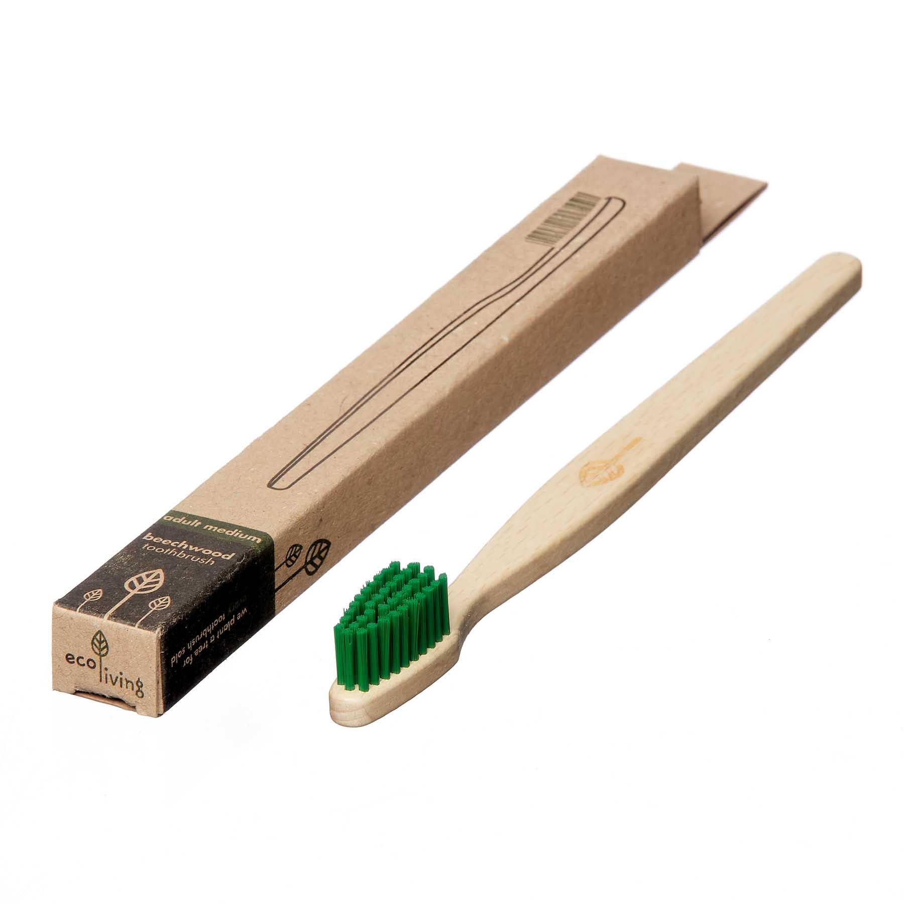 Beechwood  toothbrush with green castor oil bristles and kraft packaging shown on a white background