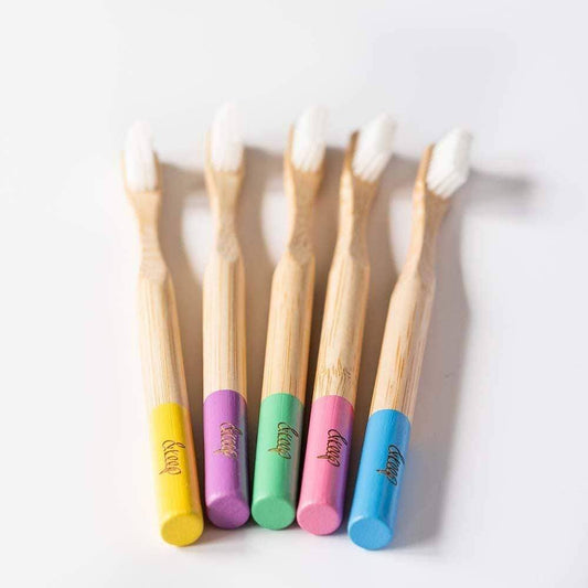 Five bamboo toothbrushes with colorful handles on a white background