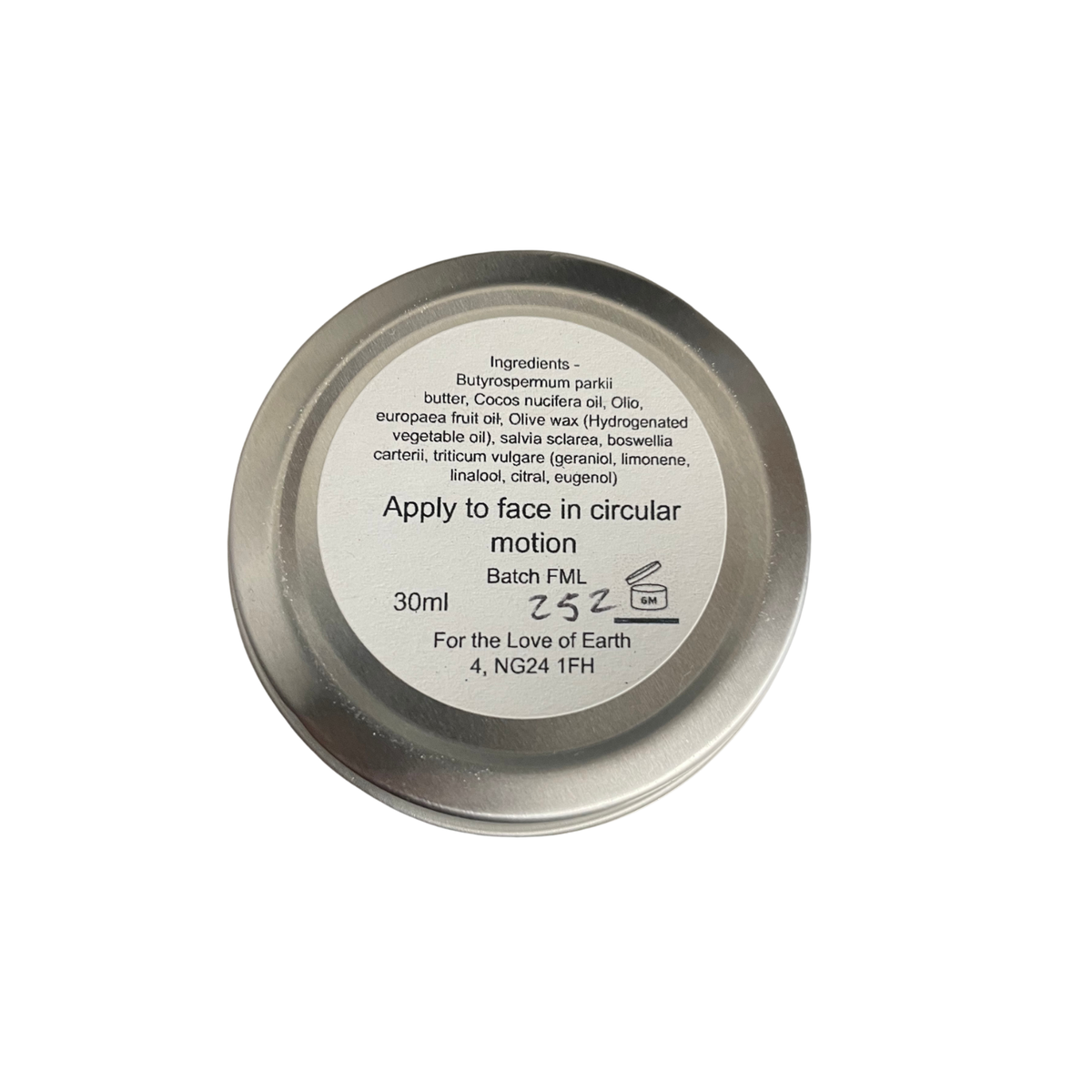 A round metal tin of face lotion with a white label showing the ingredients and application instructions, photographed on a solid white background.