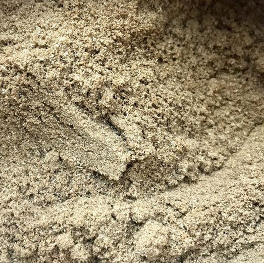 A close up image of a ground brown powder which is coriander spice.