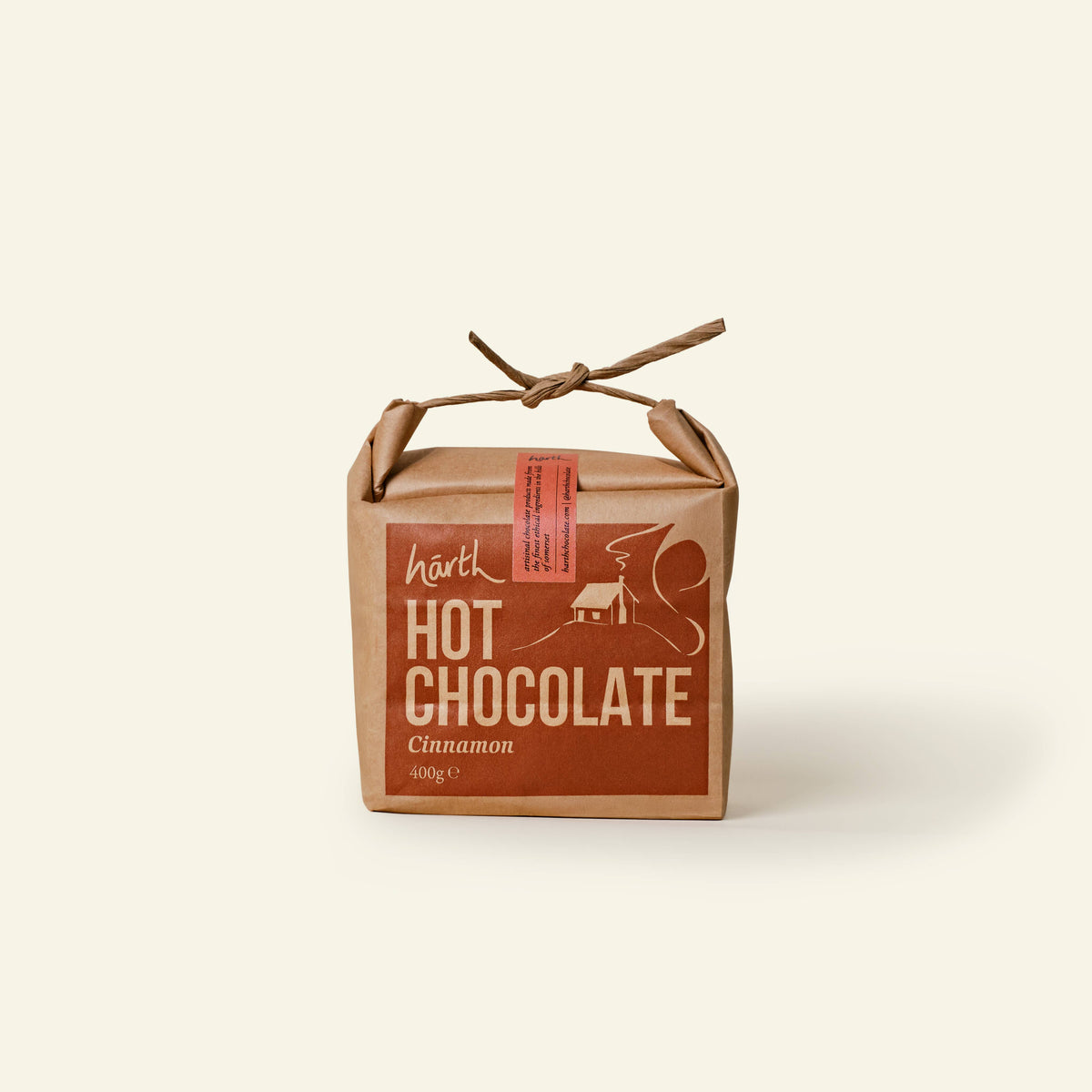 Kraft card bag of Härth Hot Chocolate powder with cinnamon flavour displayed on a beige background