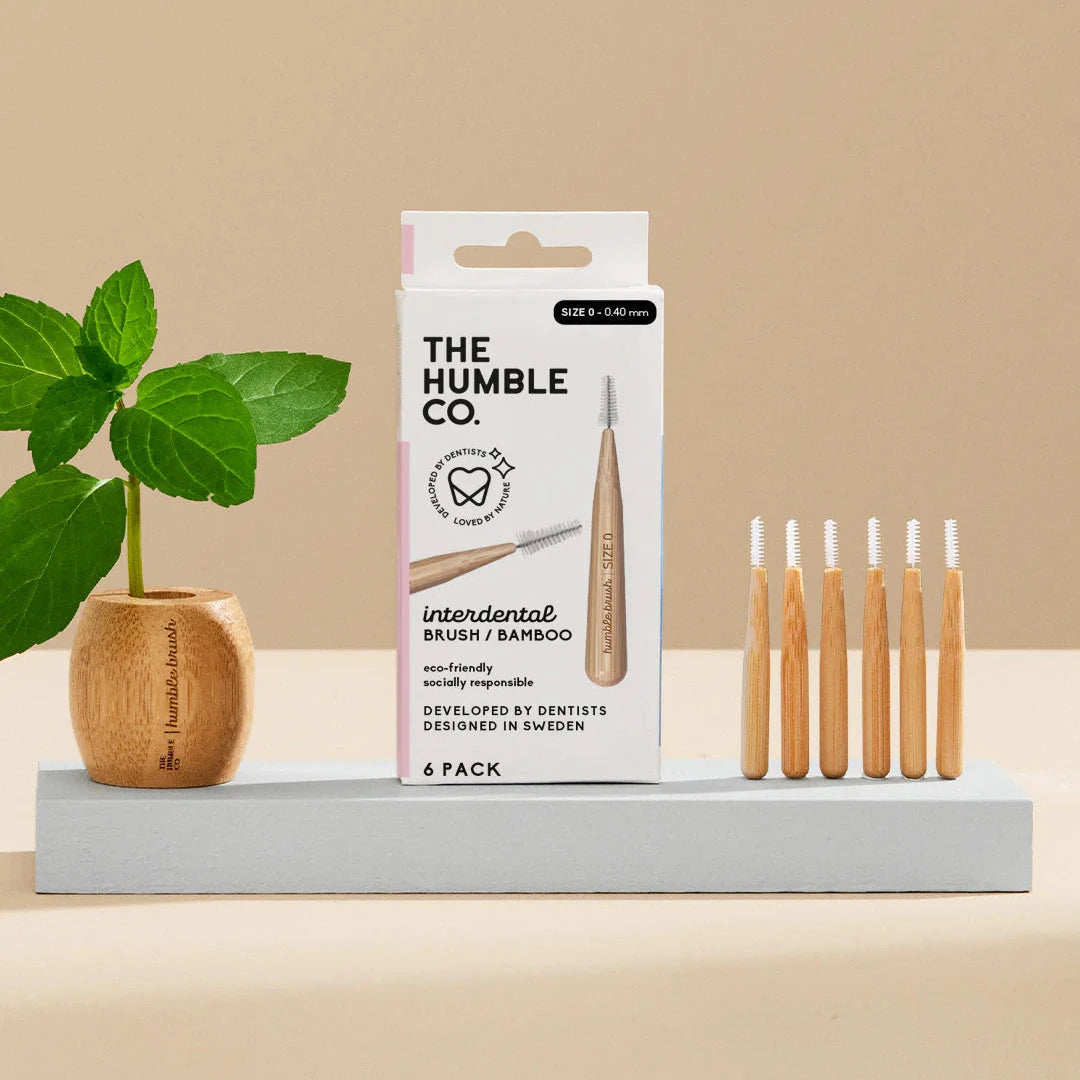 The Humble Co. interdental brushes packaging with six bamboo brushes on a beige background