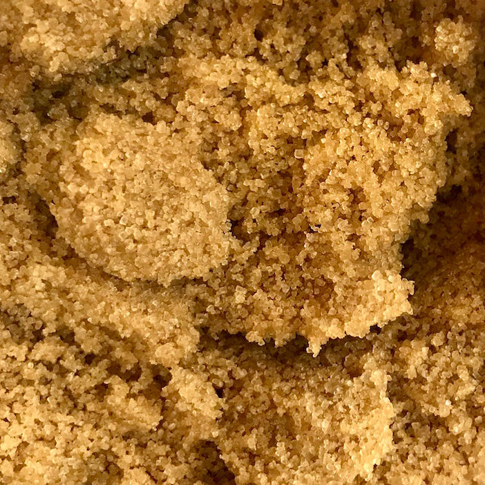 Soft Brown sugar in a glass bowl on a white background