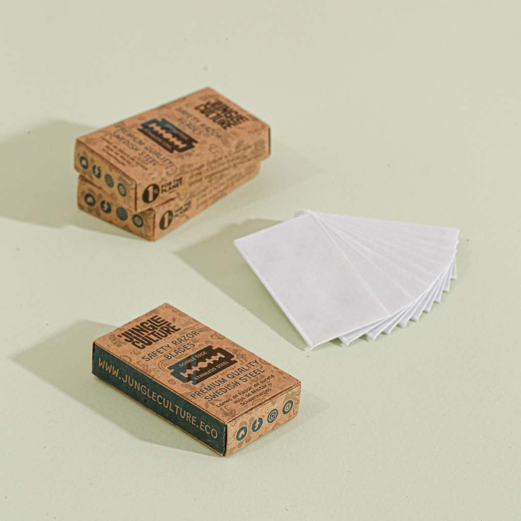 Three boxes of Jungle Culture razor blades on a light beige background, with 10 blades in white paper packaging