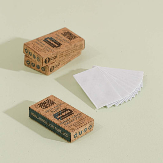 Three boxes of Jungle Culture razor blades on a light beige background, with 10 blades in white paper packaging