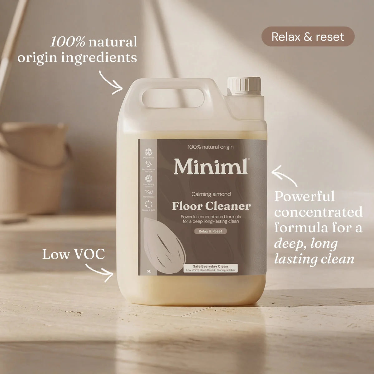 Floor cleaner bottle labeled 'Miniml' on a wooden surface with text highlighting features of the product