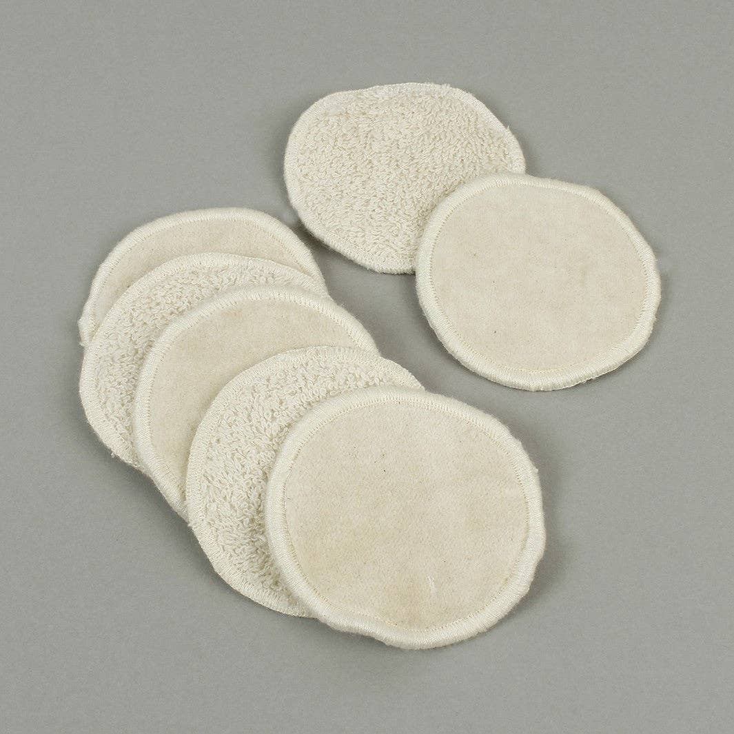 Set of beige circular facial make up pads shown on a gray background