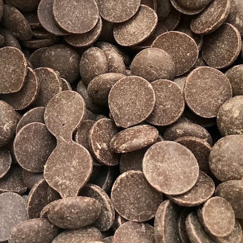 Rich chocolate drops displayed in bulk and unpackaged