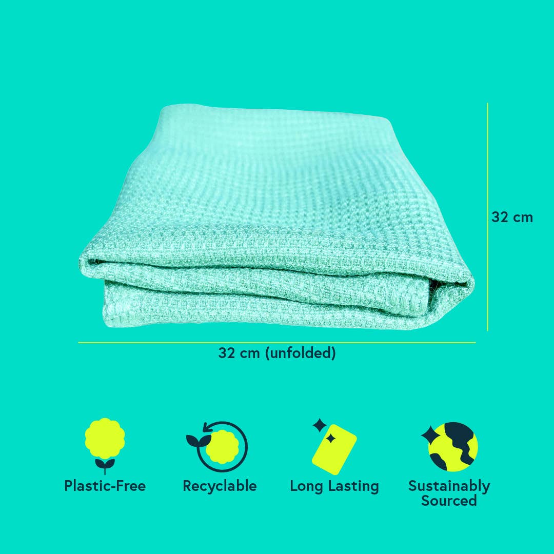 Folded green, bamboo cleaning cloth with measurements and sustainability icons on a teal background
