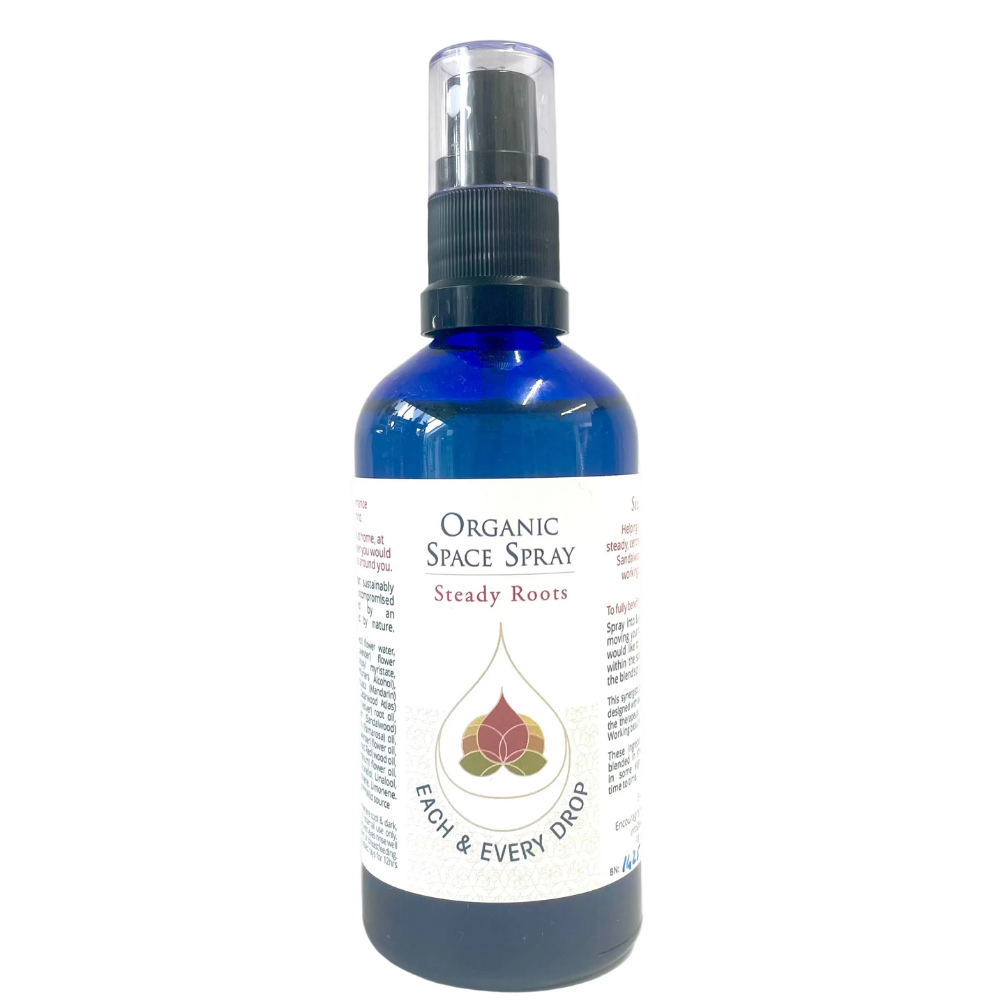 Blue organic space spray bottle with a white label on a white background