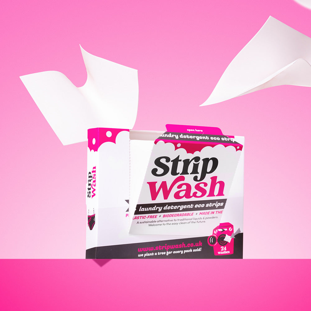 Strip Wash laundry detergent strips packaging on a pink background