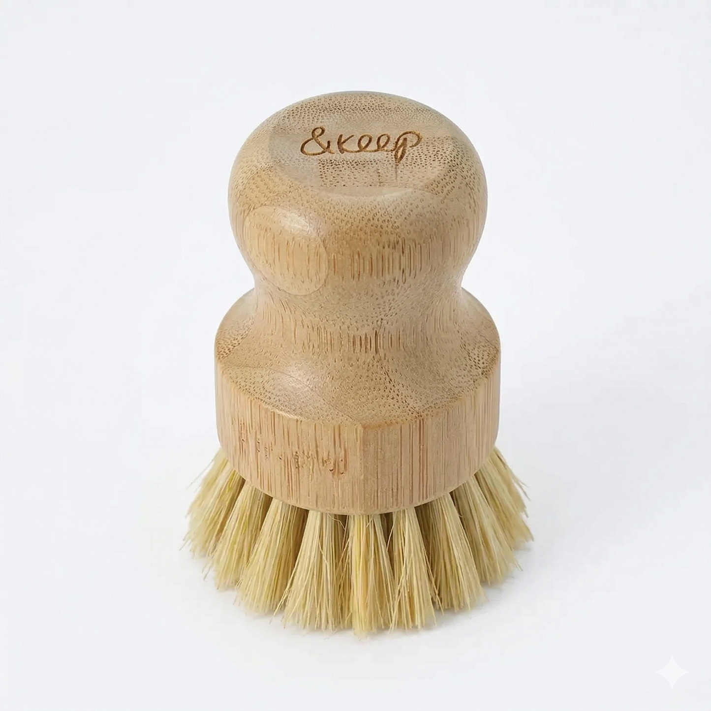 Bamboo dish brush with bristles on a white background