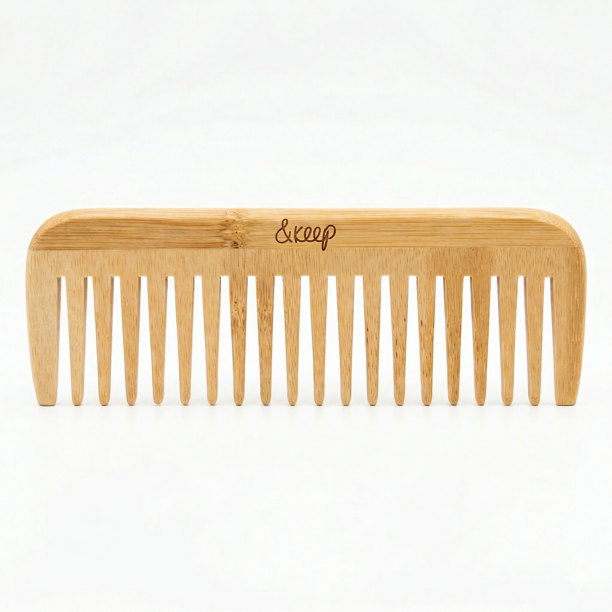 Wooden comb with '&Keep' branding on a white background