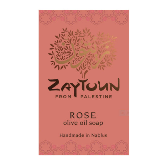 A rectangular soap bar package for Zaytoun From Palestine Rose olive oil soap, featuring a dusty rose pink background with a metallic gold tree logo and black text.